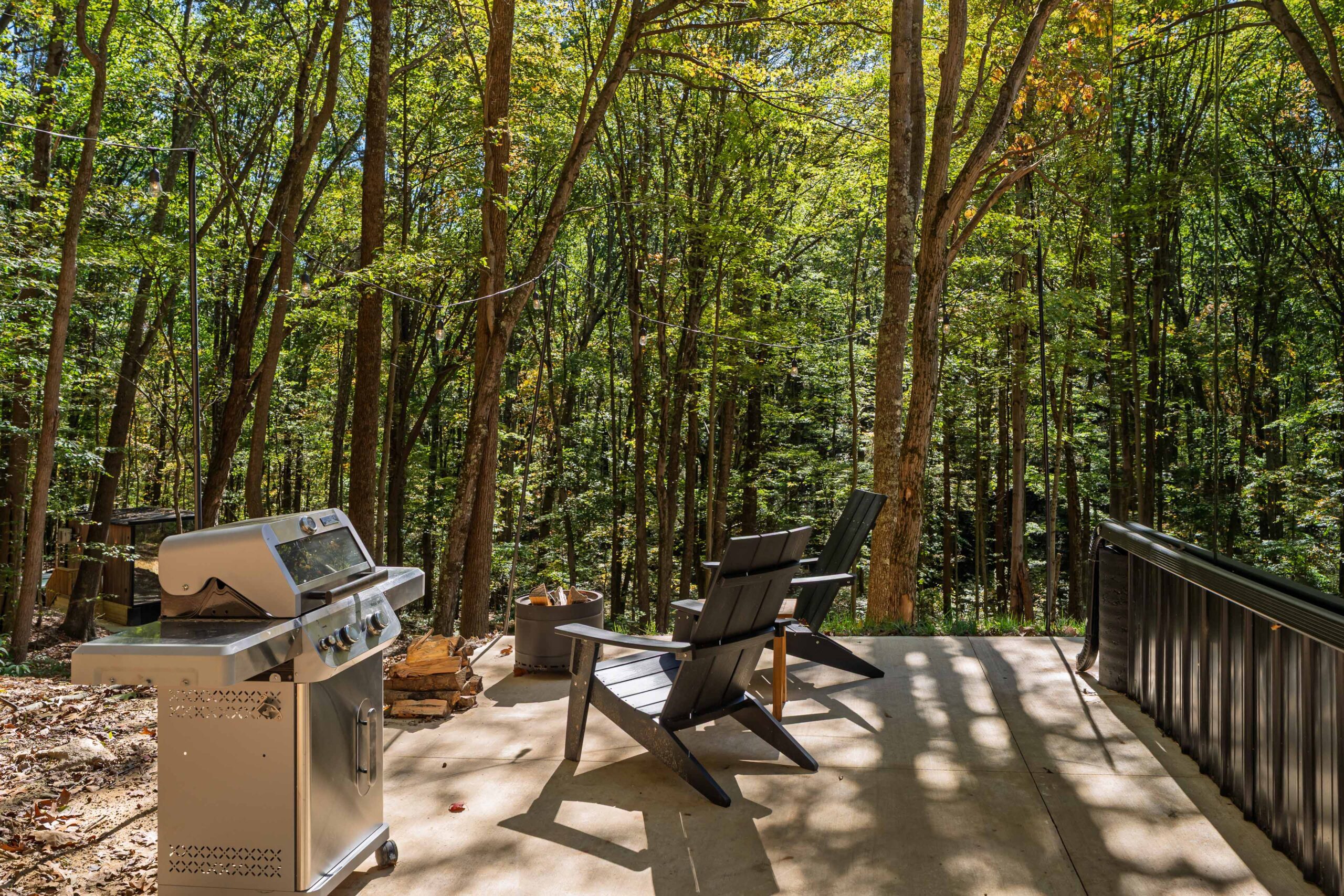 Interior view through floor-to-ceiling glass at Muir mirror home &mdash; Notestone Reserve, Hocking Hills Ohio